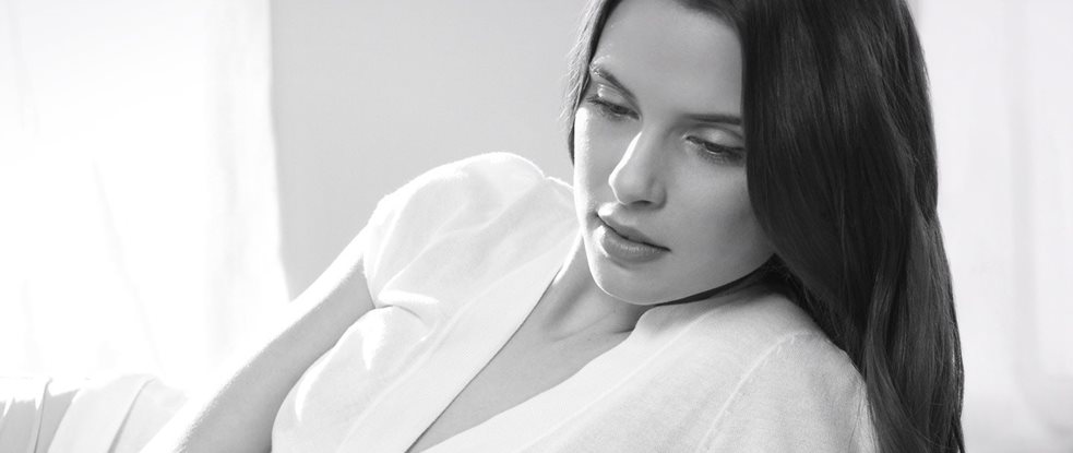 Mulher com cabelo escuro numa pose relaxada